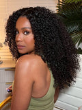 A model displays the UNice 7x5 Bye Bye Slip Black Fluffy Kinky Coils Texture Wig with Invisi Drawstring, showing a model with long curly hair and a green tank top.
