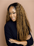 A model displays the UNice #FB30 Brown Balayage Highlight 4Pcs Jerry Curly Human Hair Bundles, showing a model with long curly hair standing in front of a wall and jerry.