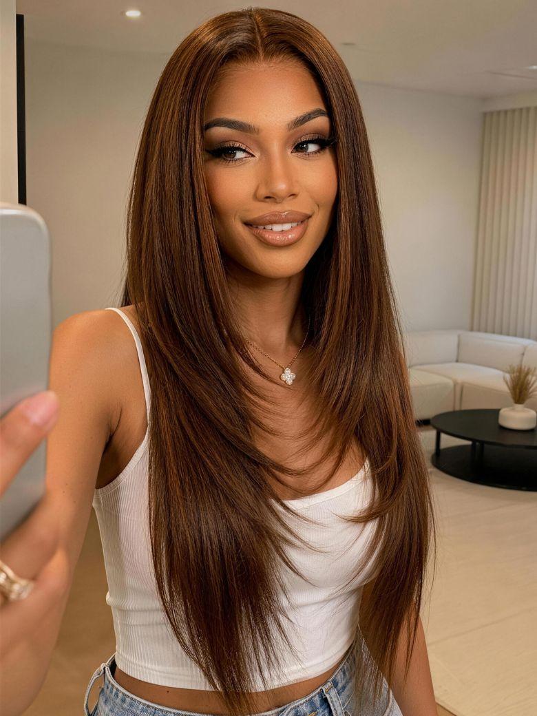 A model displays the UNice 7x5 Bye Bye Slip Lace Rich Brown with Golden Copper Highlights Layered wig, showing a model with long brown hair and a white top and straight.