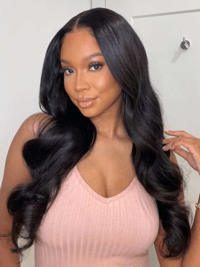 A model displays the UNice 20 Inch 5x5 HD Pre Cut Lace 0 Skill Needed Put On And Go Glueless Body Wave, showing a model with long black hair and a pink top and body wave.