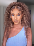 A model displays the UNice Blonde Highlight Piano Color 4 Bundles Of Curly Weave Hair Deal, showing a model with long curly hair and blue eyes and curly texture.