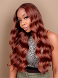 A model displays the UNice Vibrant Reddish Brown Body Wave 4Pcs 100% Remy Human Hair Bundles Deal, showing a model with long red hair and a black top and body wave.