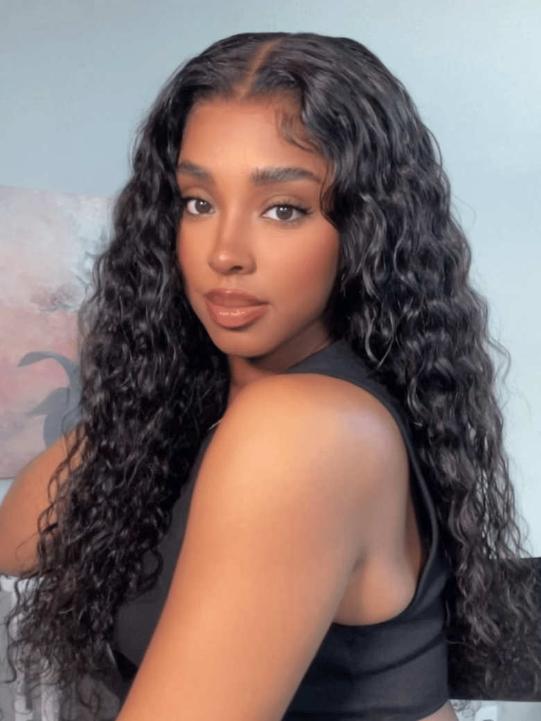 A model displays the UNice 13x4 Pre-Everything Pre-Cut Lace Front Water Wave Wig With Baby Hair &, showing a model with long curly hair and a black top and water wave.