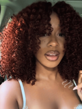 A model displays the UNice 7x5 Bye Bye Slip Wig Glueless Lace Sunset Afro Kinky Curly & Jerry Curly for, showing a model with red hair and a white bra bra and kinky.