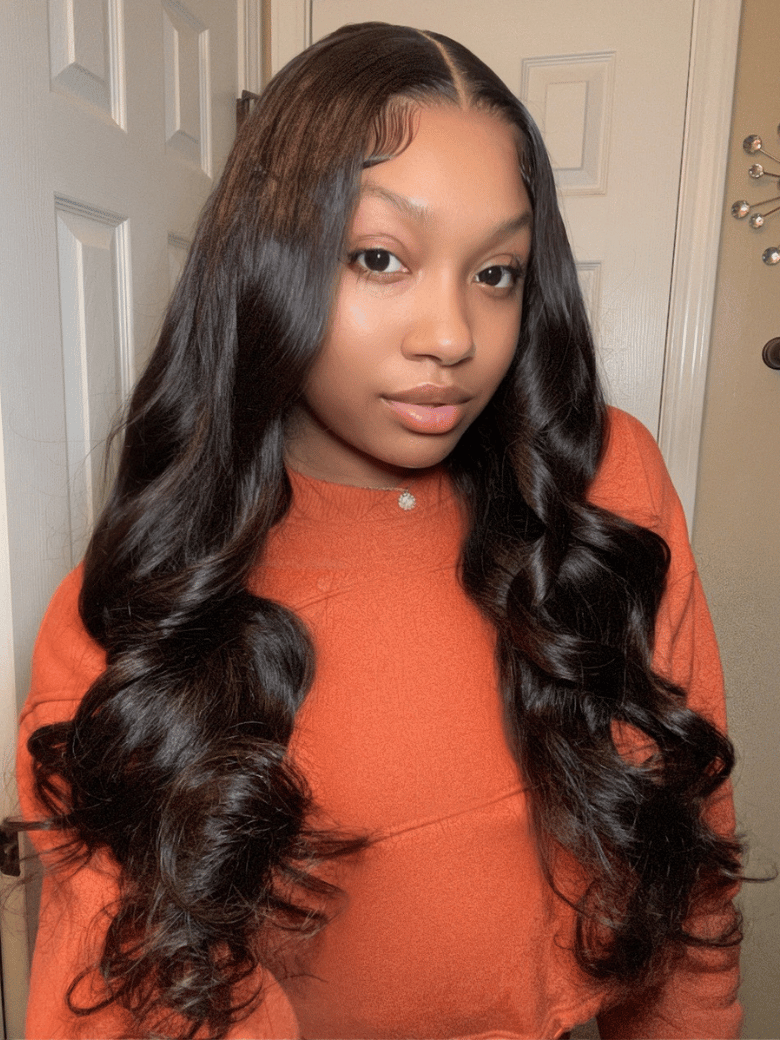 A model displays the UNice 7x5 Bye Bye Knots Body Wave Wig Pre Cut Lace Pre Plucked Hairline Put On and, showing a girl with long hair standing in front of a door.