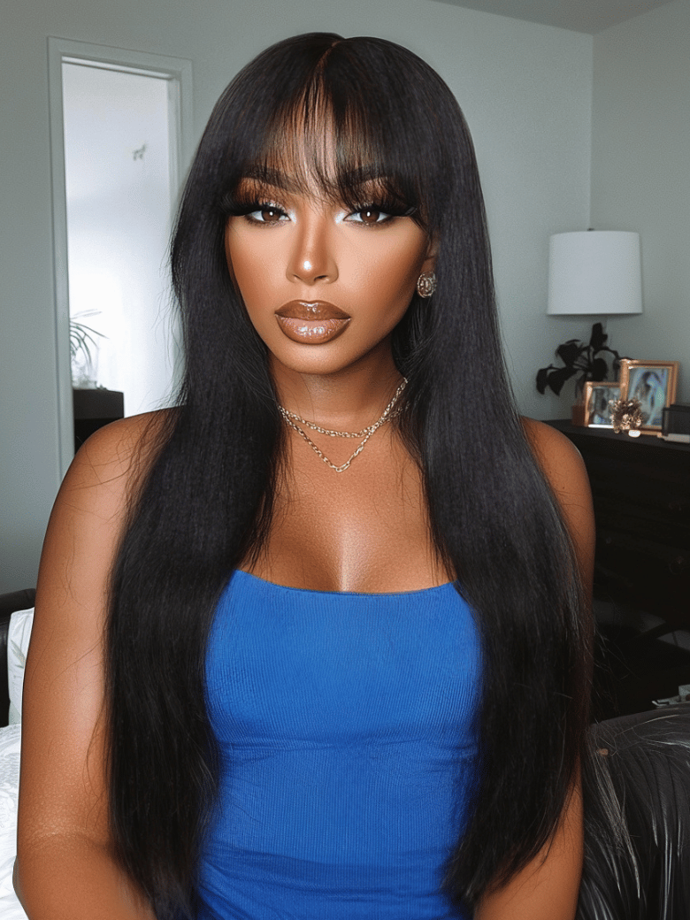 A model displays the UNice Black Yaki Texture Human Hair Glueless Wig with Blunt Bangs, showing a woman in a blue dress is posing for a picture and yaki texture.