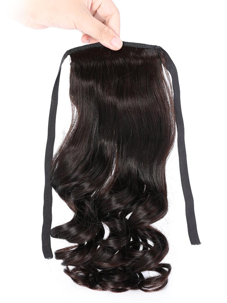 The UNice Machine-Made Natural Black Loose Wave Clip-In Ponytail Extension product image shows a person holding a piece of hair and loose wave texture, natural black.