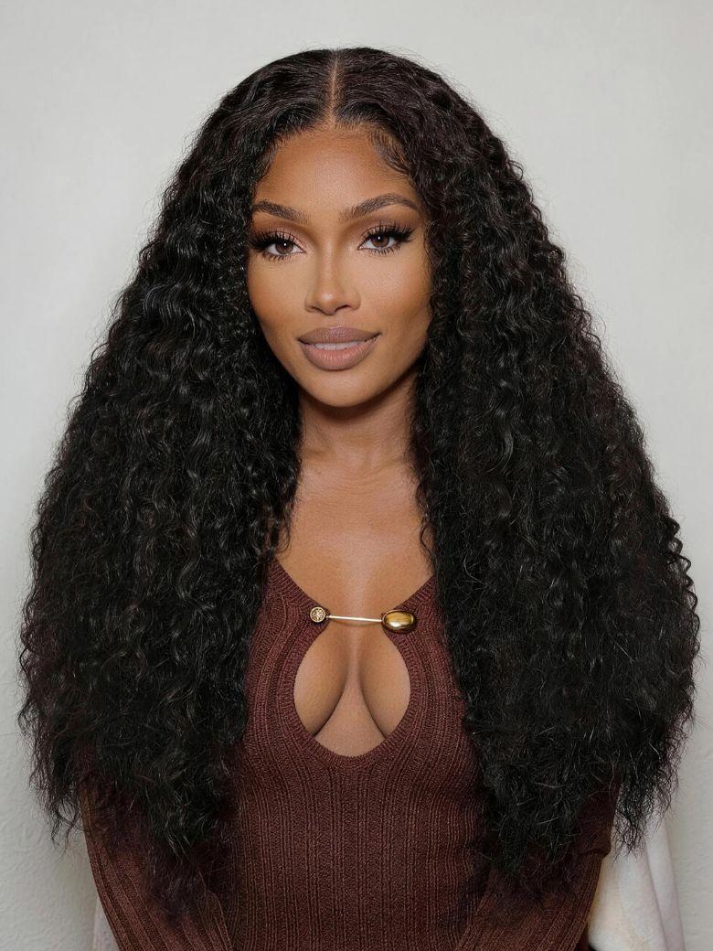 A model displays the UNice Bye Bye Knots 7x5 Lace Multi Textured Water Kinky Curly Wig with Invisi Drawstring, showing a model with long curly hair wearing a brown.