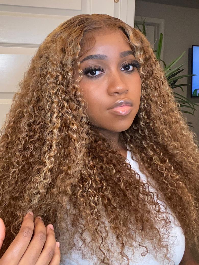 A model displays the UNice 13x4 Pre-Everything Lace Frontal Honey Blonde Highlights Jerry Curly Wig Real, showing a model with long curly hair is straightening her hair.