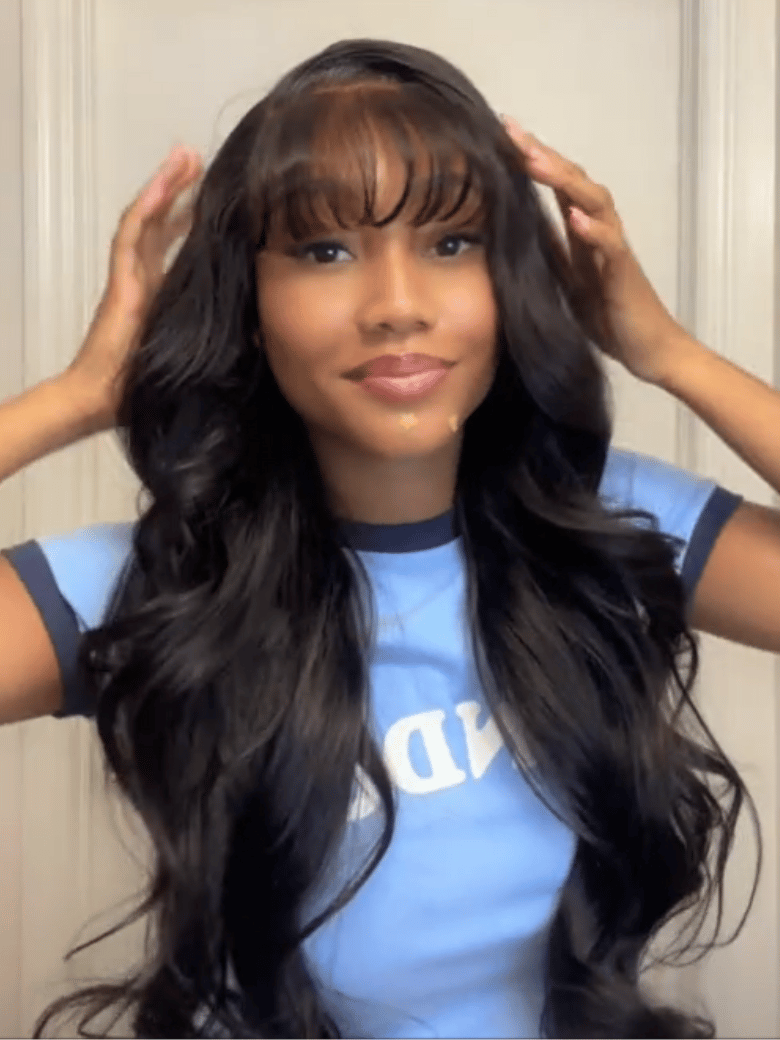 A model displays the UNice Stylish Choice UNice 13x4 Pre-Everything Side-Part Fluffy Loose Wave Wig With, showing a model with long hair and a blue shirt and loose wave.