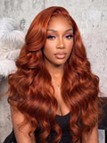 A model displays the UNice Bye Bye Slip 7x5 Lace Glueless Copper Auburn Body Wave Drawstring Wig with, showing a model with long red hair and a black top and body wave.