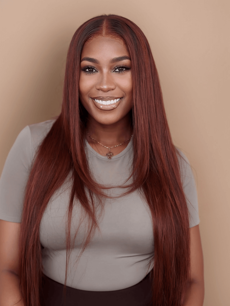 A model displays the UNice Ins Only 7x5 Bye Bye Knots Reddish Brown Kinky Curly & Straight & 13x4 wig, showing a model with long red hair and a grey shirt and loose wave.