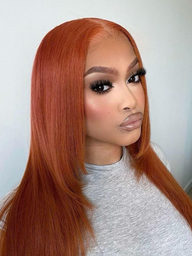 A model displays the UNice 26" Burnt Orange 13x4 Lace Front Wig 200% Density With Butterfly Wolf Layered Cut, showing a model with long red hair and a grey shirt.