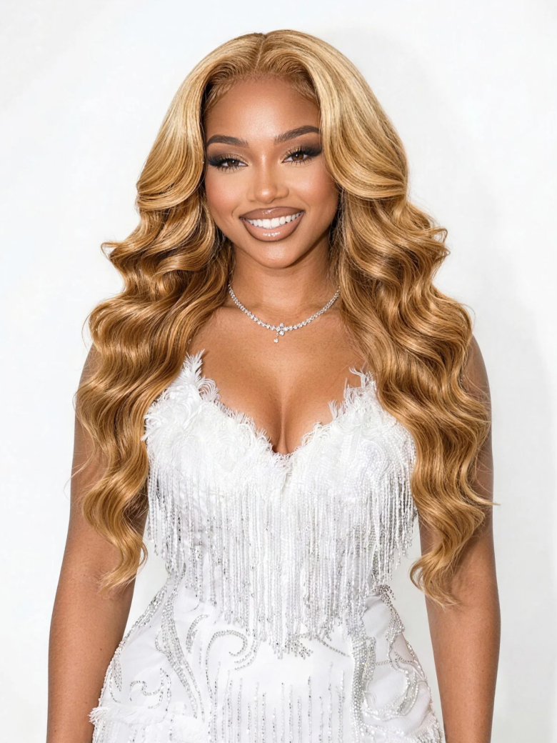 A model displays the UNice 7x5 Bye Bye Knots Wig With Drawstring Pre-Cut Glueless Lace Honey Blonde Body, showing nicki wigs by vi and body wave texture, honey blonde.
