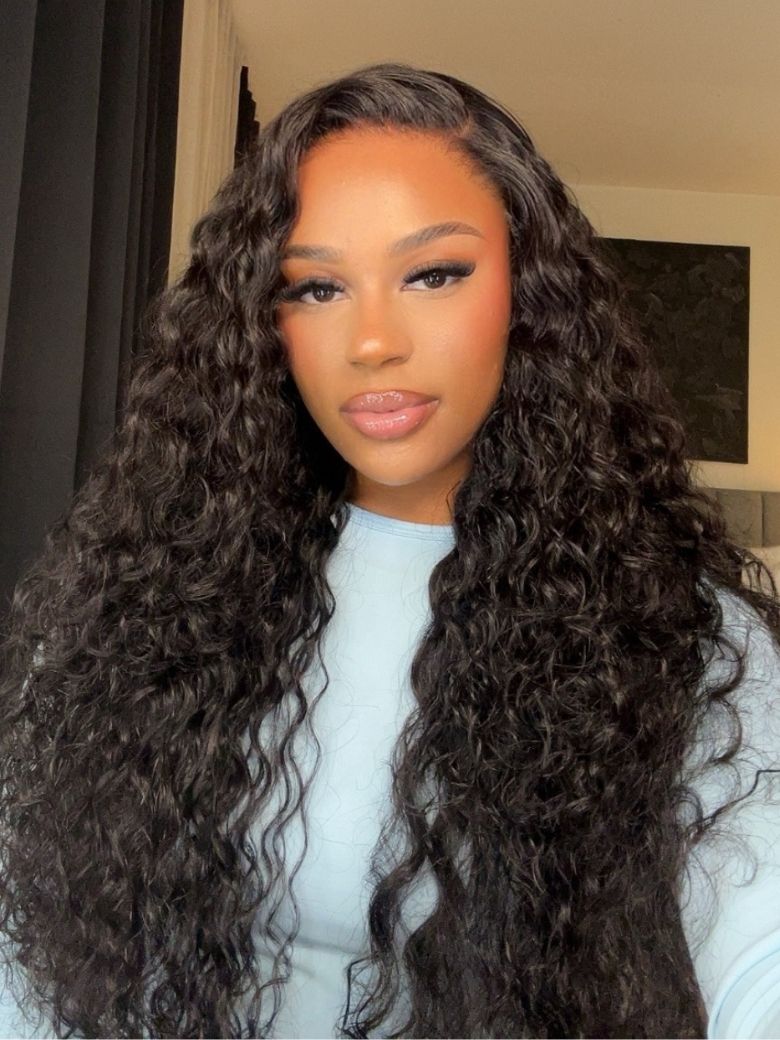 A model displays the UNice 13x4 Pre-Everything Pre-Cut HD & Transparent Lace Front Water Wave Drawstring wig, showing a model with long curly hair wearing a white.
