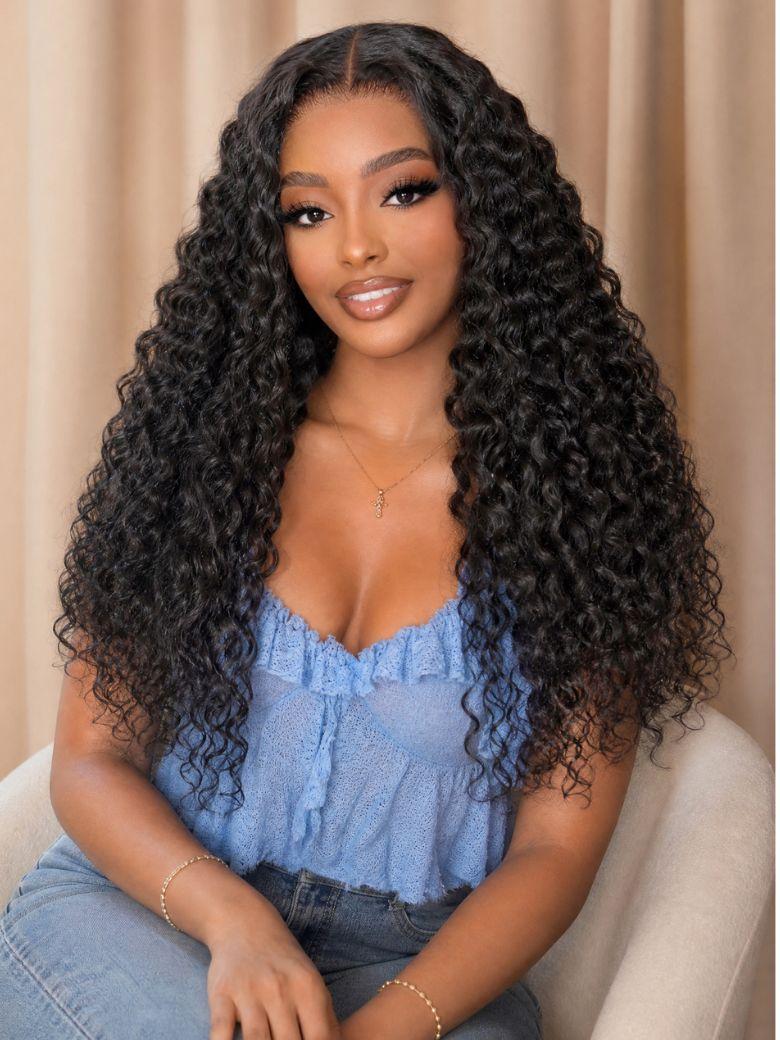 A model displays the UNice 13x4 Bye Bye Slip Lace Frontal Glueless Black Voluminous Deep Curly Wig With, showing a model with long curly hair sitting on a couch.