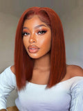 A model displays the UNice Bye Bye Slip 7x5 Lace Reddish Brown Yaki Bob Wig, showing a model with red hair and a white sweater and yaki texture, reddish brown, 7x5.
