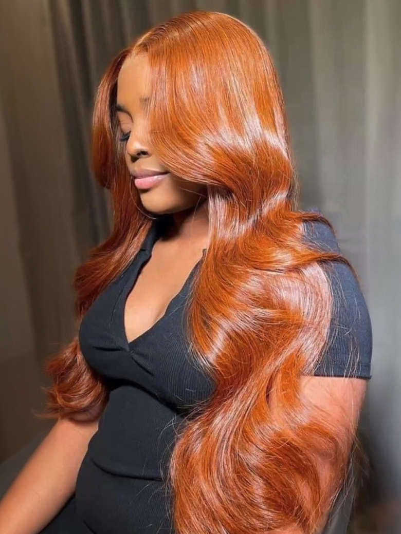 A model displays the UNice Bye Bye Knots 7x5 Lace Loose Wave Red Orange Highlights Wig with Face Framing, showing a model with long red hair wearing a black dress.