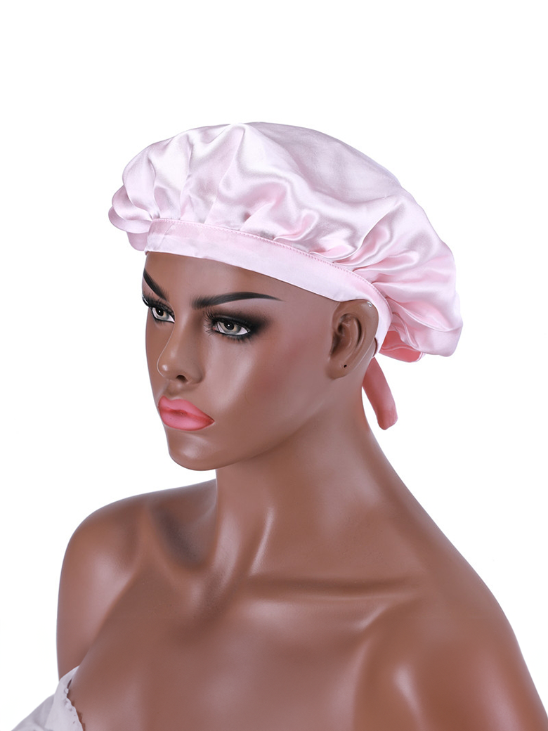 A model displays the UNice Bonus Buy Adjustable Satin Pink Night Cap Sleeping Hat For Making wig Nightcap, showing a woman wearing a pink hat with a bow.