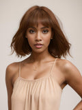 A model displays the UNice AMARA -12" MONO STRAIGHT HUMAN HAIR WIG, showing a model with a short brown hair and straight texture.