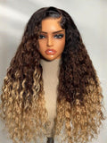 A model displays the UNice Bye Bye Knots 7x5 Lace Black to Brown to Blonde Ombre Water Wave Wig with, showing a wig with long curly hair on a mann mann and water wave.
