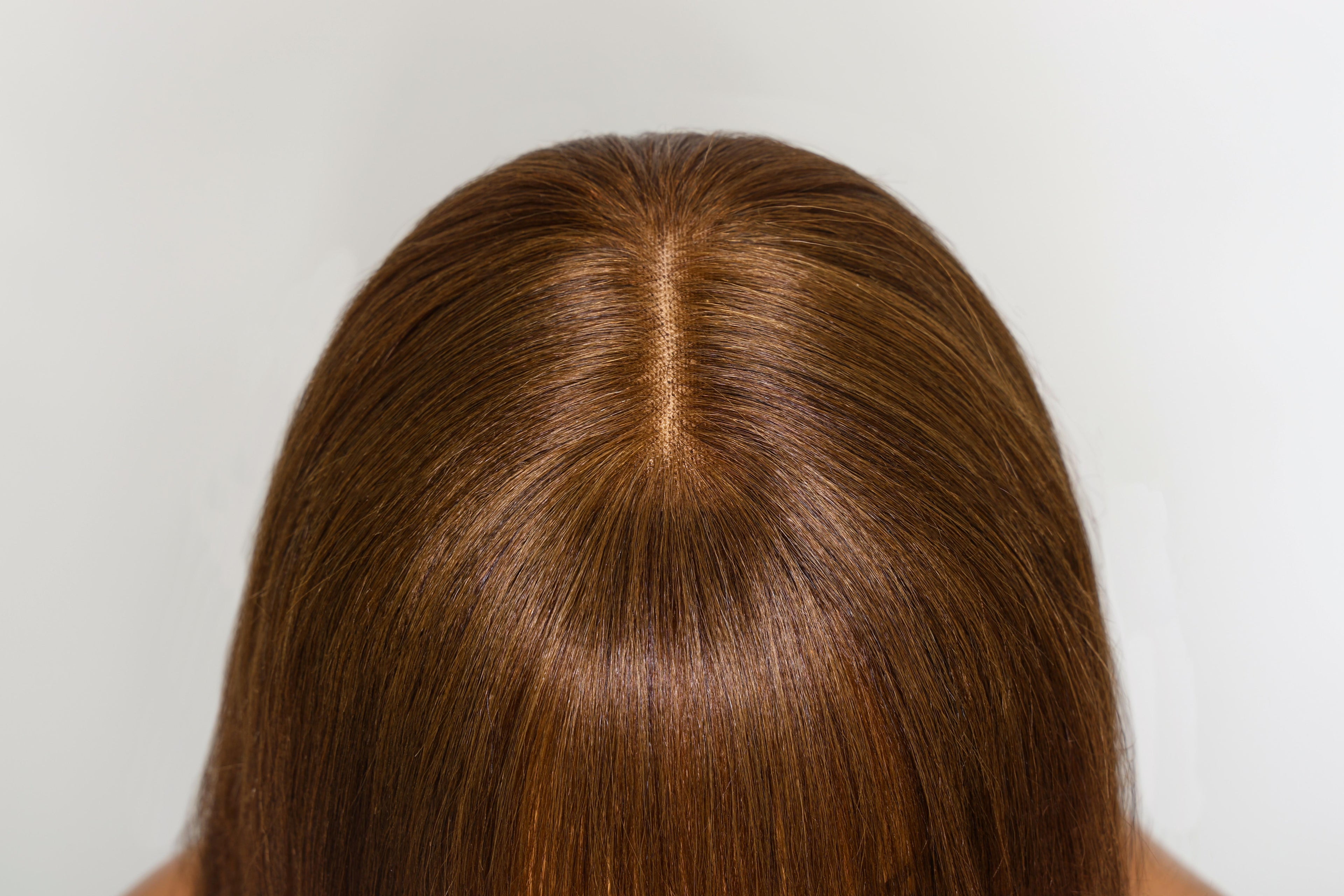 A model displays the UNice Yaki Straight human hair wig with Bangs Chocolate Brown Layered Cut 4x2, showing a model with long brown hair and straight texture, yaki.