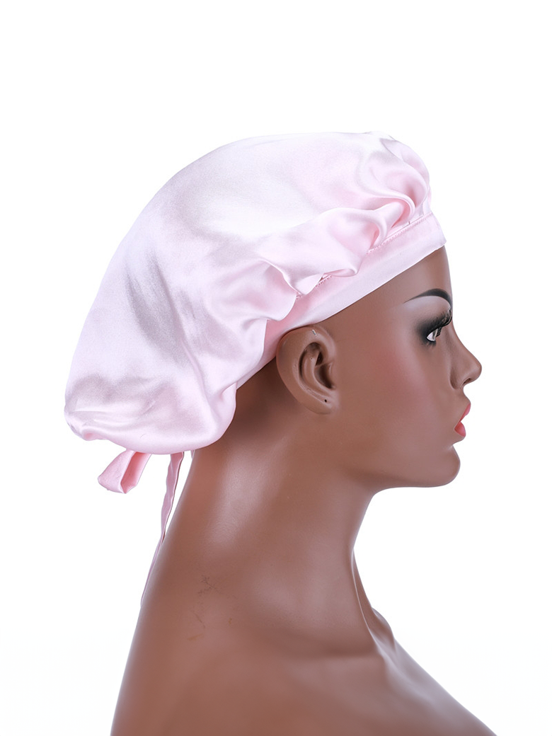The UNice Bonus Buy Adjustable Satin Pink Night Cap Sleeping Hat For Making wig Nightcap visual image position 4 shows a woman wearing a pink hat with a bow.