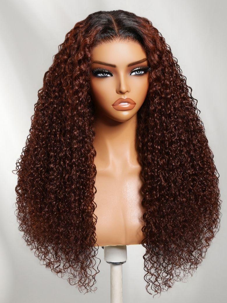 A model displays the UNice 13x4 Pre-Everything Lace Frontal Auburn Red With Dark Roots Gluless Jerry, showing a wig with curly hair on a mann and jerry curl texture.