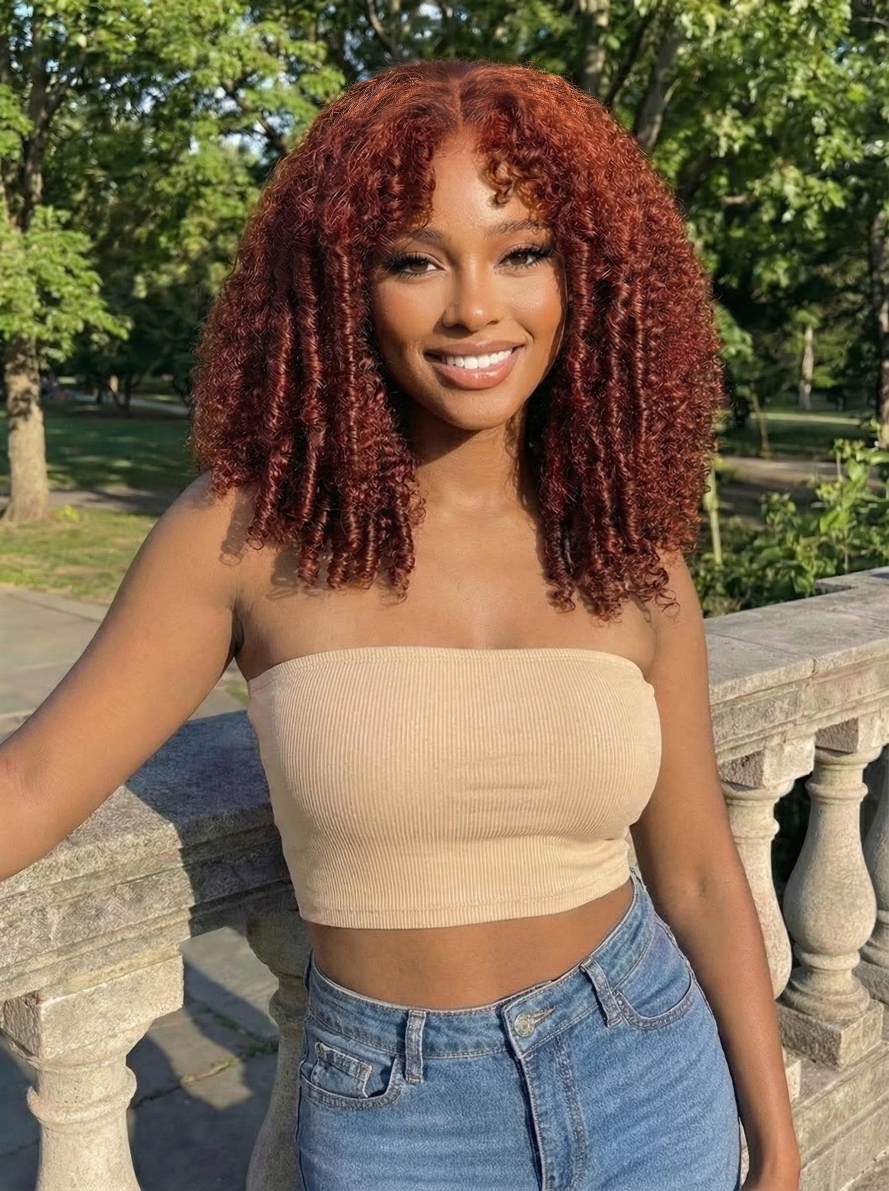 A model displays the UNice 7x5 Bye Bye Knots Wig Glueless Lace Sunset Reddish Brown Jerry Curly/ Afro, showing a model with red hair and a crop top and straight texture.