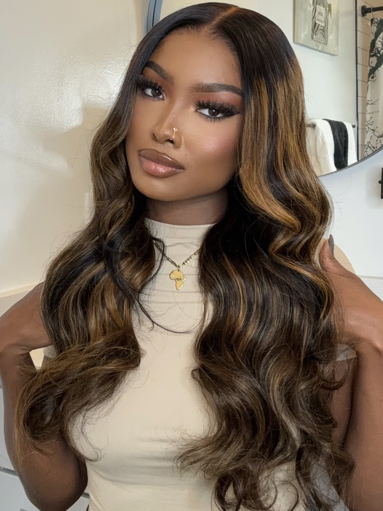A model displays the UNice 13X6 Balayage Highlight& 7x5 Bye Bye Knots Black with Caramel Blonde wig, showing a model with long brown hair wearing a white top and body.