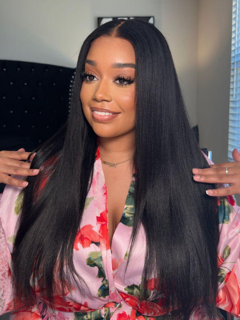 A model displays the UNice 7x5 ByeBye Knots & 13x4 Pre-Everything Wig Glueless Lace Yaki Straight Wig, showing a model with long black hair wearing a pink floral shirt.