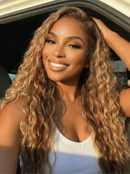A model displays the UNice 13x4 Bye Bye Slip Lace Frontal Caramel Brown With Honey Blonde Highlights, showing a model with long curly hair and a white tank top and water.