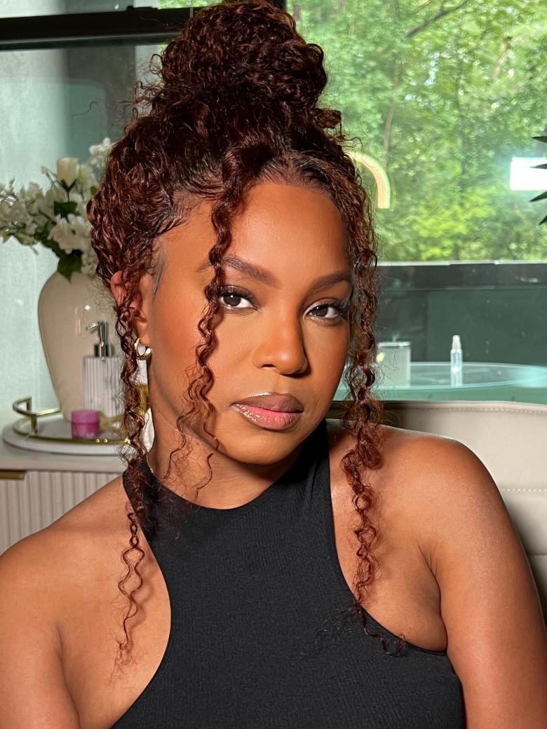 A model displays the UNice 7x5 Glueless Lace Bye Bye Knots Wig Sunset Jerry Curly for Reddish Brown, showing a model with curly hair and jerry curl texture, curly.
