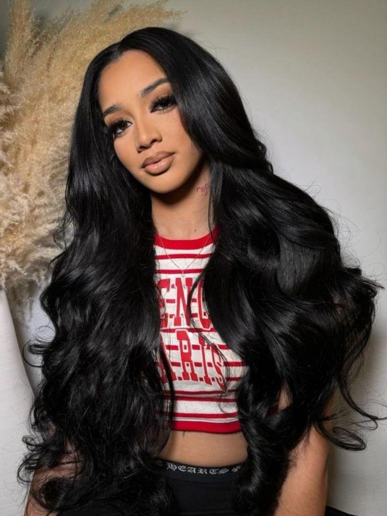A model displays the UNice InvisiBlend V part Natural Black Glueless Body Wave Wig Protect Your Natural Hair, showing a model with long black hair and a red and white.