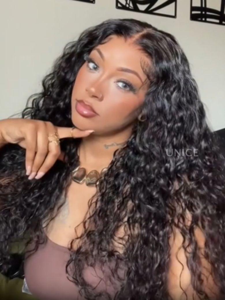 A model displays the UNice Limited Time 7x5 Drawstring Bye Bye Knots Wig Quick Glueless Wet & Wavy Water, showing a model with long curly hair and a brown bra and water.