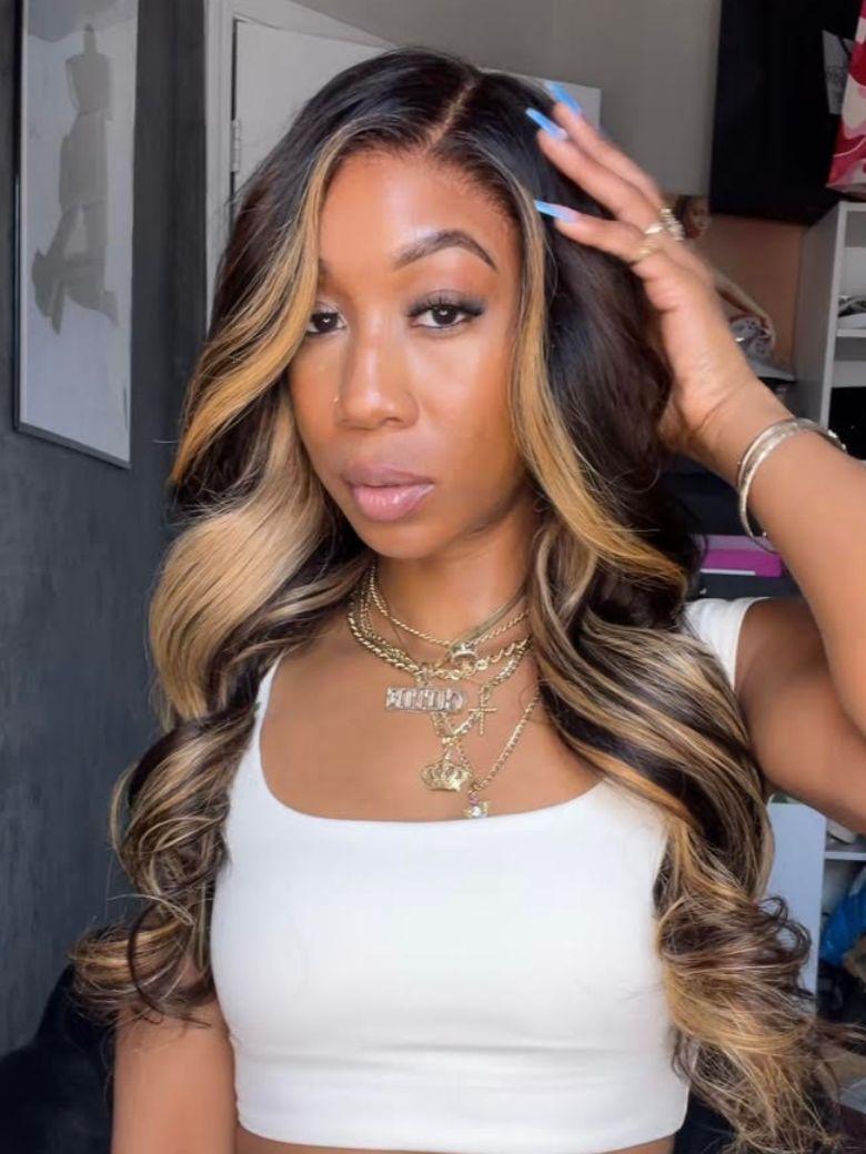 A model displays the UNice 7x5 Bye Bye Slip Lace Loose Wave Butterscotch Highlights Brown with Free Face wig, showing a model with long hair wearing a white crop top.