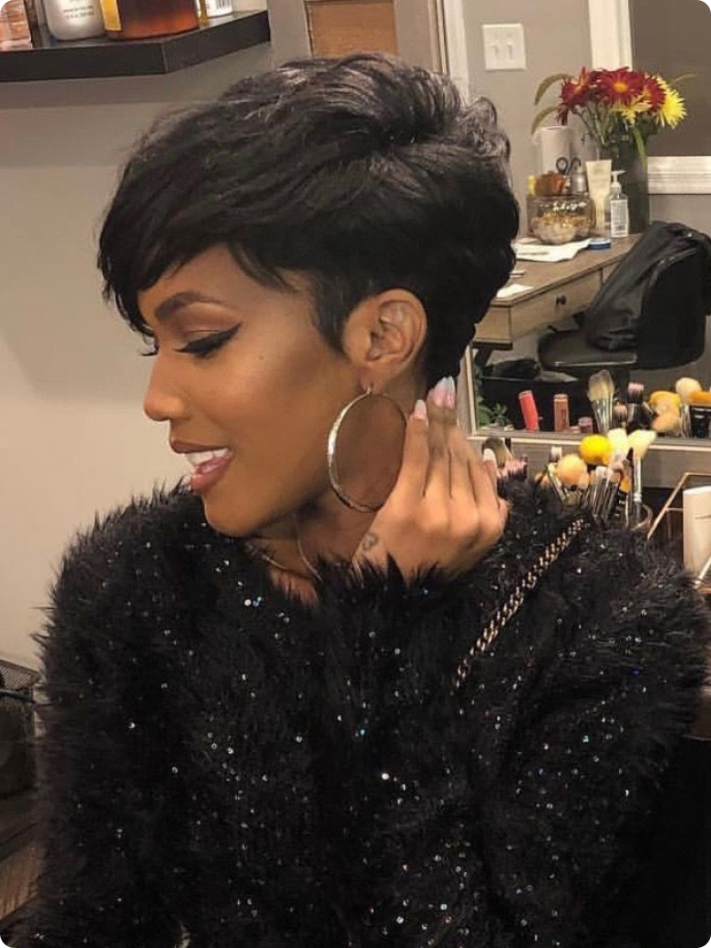 A model displays the UNice 7x5 Bye Bye Knots Wig Quick Glueless & HD Lace Wet & Wavy Water Wave Invisible, showing a model with short hair and a black jacket and water.