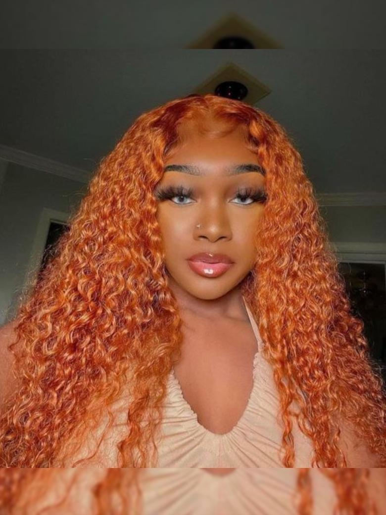 A model displays the Unice Lace Part 150% Density Ginger Color Jerry Curly Human Hair Wig With Invisible, showing a model with long red hair and a white dress and jerry.