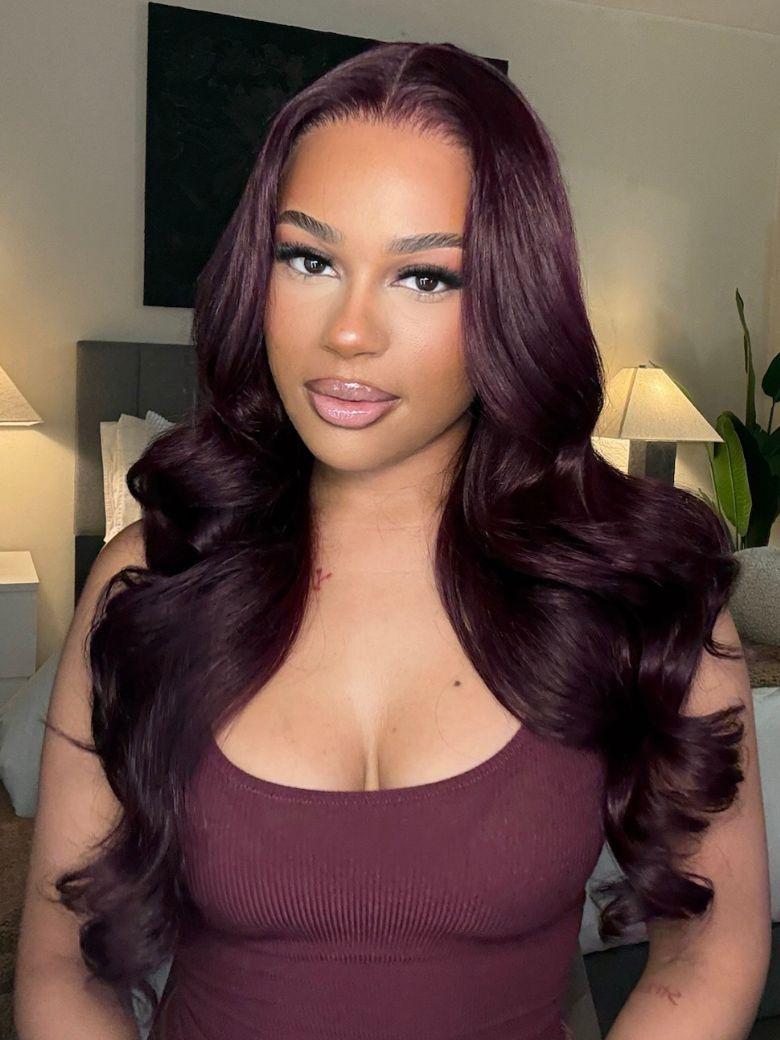 A model displays the UNice " 13x4 Pre-Everything Purple Black Cherry Layered Straight& Loose Wave Invisi wig, showing a model with long dark purple hair and a purple top.