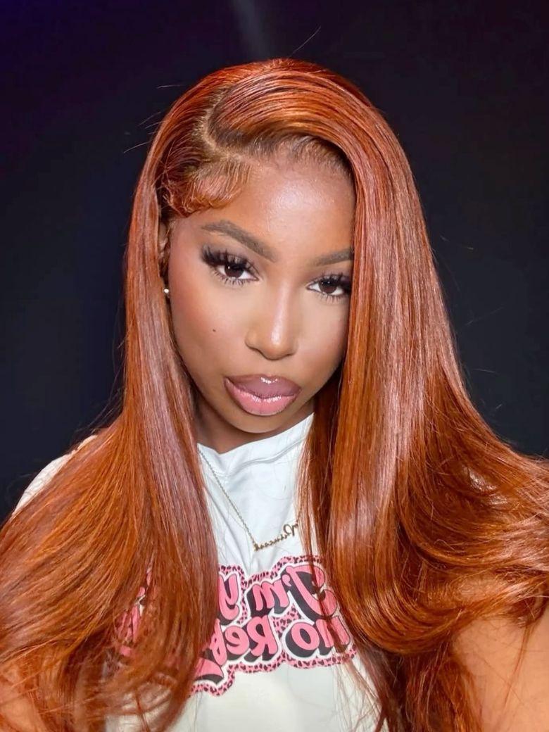 A model displays the UNice 26" Burnt Orange 13x4 Lace Front Wig 200% Density With Butterfly Wolf Layered Cut, showing a model with long red hair and a white shirt.