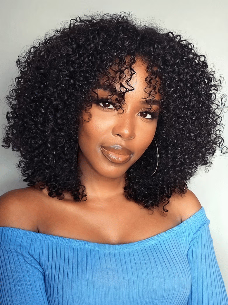 A model displays the UNice New V Part Kinky Curly Glueless 0 Skill Needed Wig, showing a model with curly hair wearing a blue top and kinky curly texture, curly texture.
