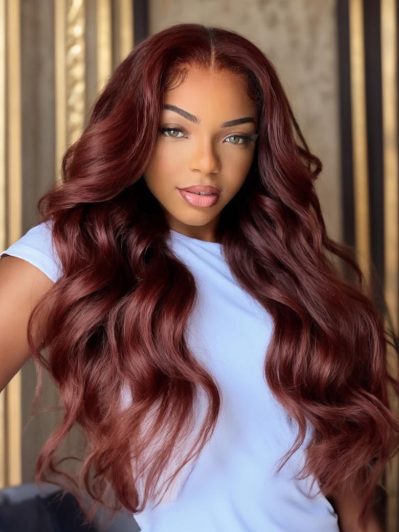 A model displays the UNice 7x5 Bye Bye Slip Wig Glueless Lace 150% density Flattering Sun-Kissed Warm, showing a model with long red hair and a white shirt and body wave.