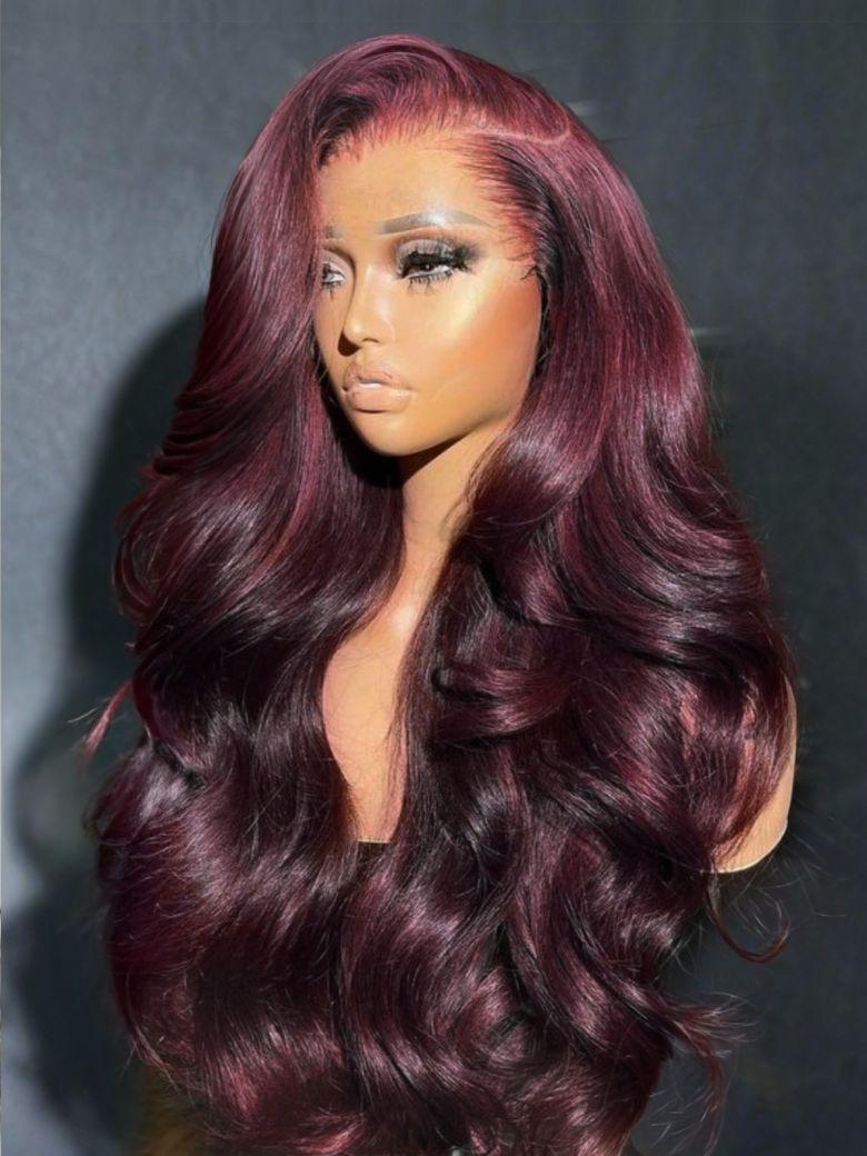 A model displays the UNice Bye Bye Knots 13x4 Lace Frontal Purple Black Cherry Layered Straight & Loose, showing burgundy red wig with long wavy hair and loose wave.