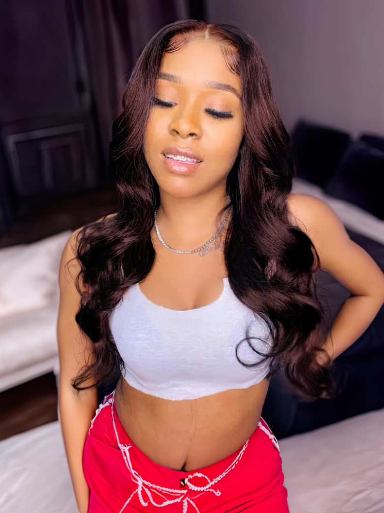 A model displays the UNice Hair Dark Brown Color Human Hair 1 Bundle #2 Color Body Wave Straight, showing a woman in red shorts and a white top and body wave texture.