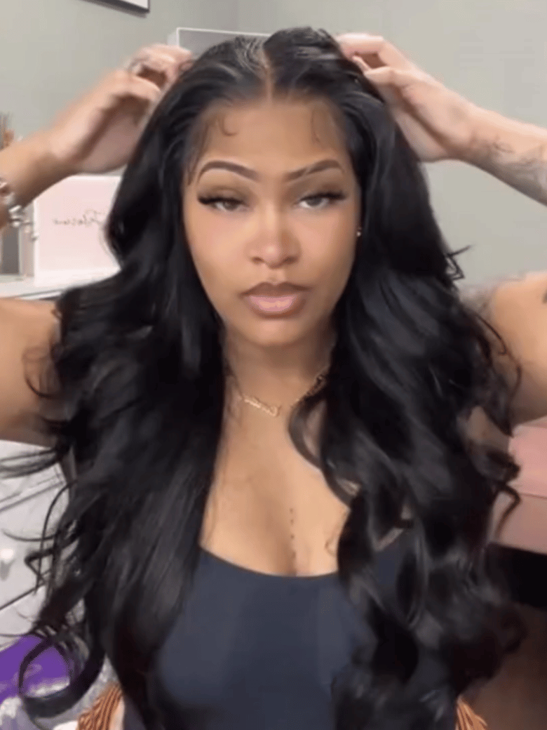 A model displays the UNice 13x4 HD Lace Bye Bye Slip Body Wave Wig - Pull & Go Fit Ear-to-Ear with Invisi, showing a model with long black hair is getting her hair done.