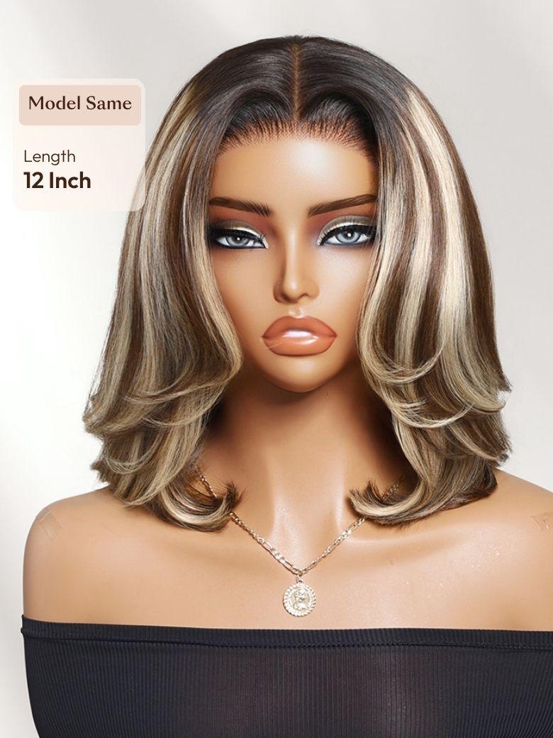 A model displays the UNice Bye Bye Slip 7x5 Lace Warm Brown with Beige Blonde Ribbon Highlights Layered wig, showing a model with blonde hair and a black top.