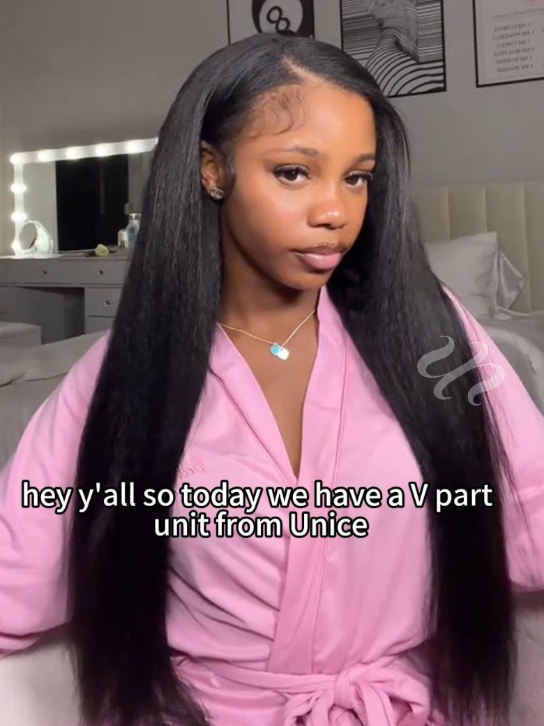 A model displays the UNice Kinky Straight When Wet InvisiBlend V Part Silk Press To Blow Out Kinky wig, showing a model with long hair wearing a pink robe and kinky.