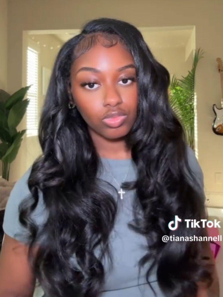 A model displays the UNice Kinky Straight When Wet InvisiBlend V Part Silk Press To Blow Out Kinky wig, showing a model with long hair wearing a grey top and a grey top.