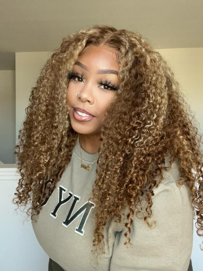 A model displays the UNice 13x4 Pre-Everything Lace Frontal Honey Blonde Highlights Jerry Curly Wig Real, showing a model with long curly hair wearing a grey sweatshirt.
