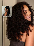The UNice EasiContour V Part Minimal Glueless Curly Glueless Wig Invisi Drawstring Human visual image position 3 shows a model with long curly hair and a smile | visible.